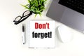 DON'T FORGET text on notebook with laptop, mouse and pen Royalty Free Stock Photo