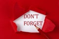 DON`T FORGET text on the red torn paper with red pencil Royalty Free Stock Photo