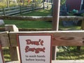 Don`t forget to wash hands sign on wood fence at farm Royalty Free Stock Photo