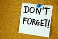 don 't forget written on color sticker notes over cork board background Royalty Free Stock Photo