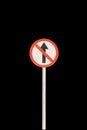 Don`t go straight arrow with red edge circular badge with old rusted iron pole. Traffic sign signage. isolated with black Royalty Free Stock Photo