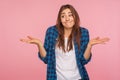 Don`t know answer! Portrait of funny confused girl shrugging shoulders with clueless embarrassed expression Royalty Free Stock Photo