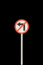 Don`t left arrow with red edge circular badge with old rusted iron pole. Traffic sign signage. isolated with black background Royalty Free Stock Photo