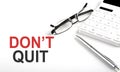 DON`T QUIT Concept. Calculator,pen and glasses on the white background Royalty Free Stock Photo