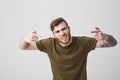 Don`t talk to me like that, man. Portrait of young bearded attractive aggressive man with tattooed arm and short hair in Royalty Free Stock Photo
