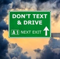 DON'T TEXT & DRIVE road sign against clear blue sky