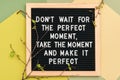 Don`t wait for the perfect moment, take the moment and make it perfect. Motivational quote on letter board frame and spring tree