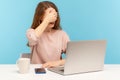 Don`t want to look at this. Confused scared woman covering her eyes, avoid watching shameful content on laptop Royalty Free Stock Photo