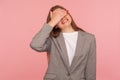 Don`t want to look! Portrait of displeased young woman in business suit covering eyes with hand, her face expressing disgust Royalty Free Stock Photo