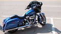A blue Harley Davidson motorcycle waits for its owner.