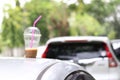 Coffee cup on car roof