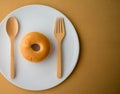 Donat fork spoon on white plate