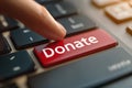 Donate Blood Concept with Red Keyboard Button and Finger Encouraging Generosity and Support in Royalty Free Stock Photo