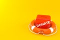 Donate box inside life buoy Royalty Free Stock Photo