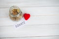 Donate conception. Jar with money on white wood background Royalty Free Stock Photo