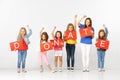 Donate. Group of children with red banners isolated in white Royalty Free Stock Photo