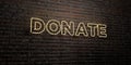 DONATE -Realistic Neon Sign on Brick Wall background - 3D rendered royalty free stock image Royalty Free Stock Photo