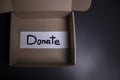`Donate` sign handwritten with black letters in a box. donation concept. Context of The Coronavirus Pandemic. copy space