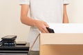 Donate technology to charity. Volunteer hands collect old used laptop computers, phone, tablet in cardboard box Royalty Free Stock Photo