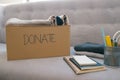 Donation box and casual clothes in livingroom Royalty Free Stock Photo