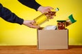 Donation box with food. and hands of a volunteer. Macaroni, buckwheat, canned food, oil filling in a box. Volunteer