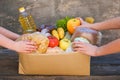 Donation box with food on old wooden background