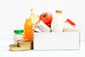 Donation box with food supplies for the period of quarantine on white background. Set of grocery items from canned food Royalty Free Stock Photo