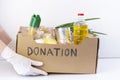 donation box. in hands in rubber gloves is a cardboard box with the inscription donation Royalty Free Stock Photo