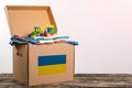 Donation box with Humanitarian aid with children`s things and toys for Ukrainian refugees. Charity and Helping poor and needy