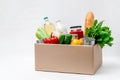 Donation Box with Supplies Food for People in Isolation on Light Background. Essential Goods Royalty Free Stock Photo