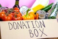 Donation carton box with food pasta, cans, vegetables and other. Volunteering and social assistance, charity concept.