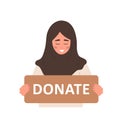 Donation and charity concept. Arabic volunteer woman holding in hands cardboard sign Donate. Support for homeless and Royalty Free Stock Photo