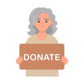 Donation and charity concept. Elderly volunteer woman holding in hands cardboard sign Donate. Support for homeless and poor people