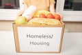 Donation and charity for the homeless. Women`s hands holding a box of food products