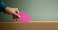 Donation Concept. Hand Dropping a Pink Paper Heart into a Donate Box. Helping, Supporting and Togetherness.