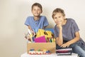 Donation concept. Kids holding donate box with books and school supplies, clothes and toys