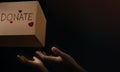 Donation Concept. The Volunteer Giving a Donate Box to the Receiver