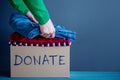 Donation Concept. Woman Preparing her Used Old Clothes into a Do