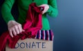 Donation Concept. Woman Preparing her Used Old Clothes into a Do