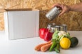 Donation empty box with food near the box and mans hand