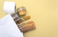 Corn, buckwheat, bananas, milk, bread in white bag on yellow background Royalty Free Stock Photo