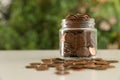 Donation jar with coins on table against blurred background Royalty Free Stock Photo