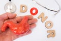 Donation of stomach and hand of donor concept photo. Word of 3D letters donor with letter O as symbol of that donation replace mis Royalty Free Stock Photo