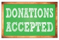 DONATIONS ACCEPTED words on green wooden frame school blackboard