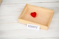 Donations and Charity. Donation Concept. Box of Donations and Heart on the White Background. Royalty Free Stock Photo