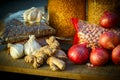 Donations food with rice, lentils, onions, ginger, peanuts on wooden surface