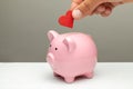 Donations of love and feelings, sympathy. Man puts heart in piggy bank Royalty Free Stock Photo