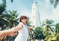 Dondra lighthouse in Sri Lanka: woman traveler take for hand her