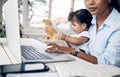 Done and dusted. a young mother caring for her baby girl while working from home. Royalty Free Stock Photo