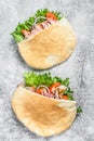 Doner kebab with grilled chicken meat and vegetables in pita bread. Gray background. Top view Royalty Free Stock Photo